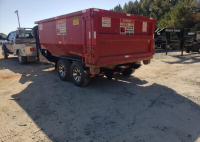 Knight Container Service truck delivering a roll-off dumpster